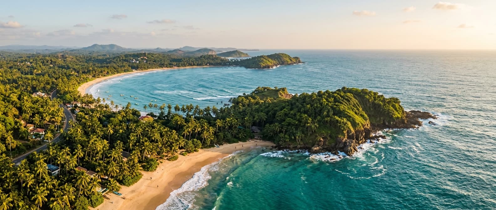Aerial view of a palm-fringed bay on Sri Lanka's south coast at golden hour